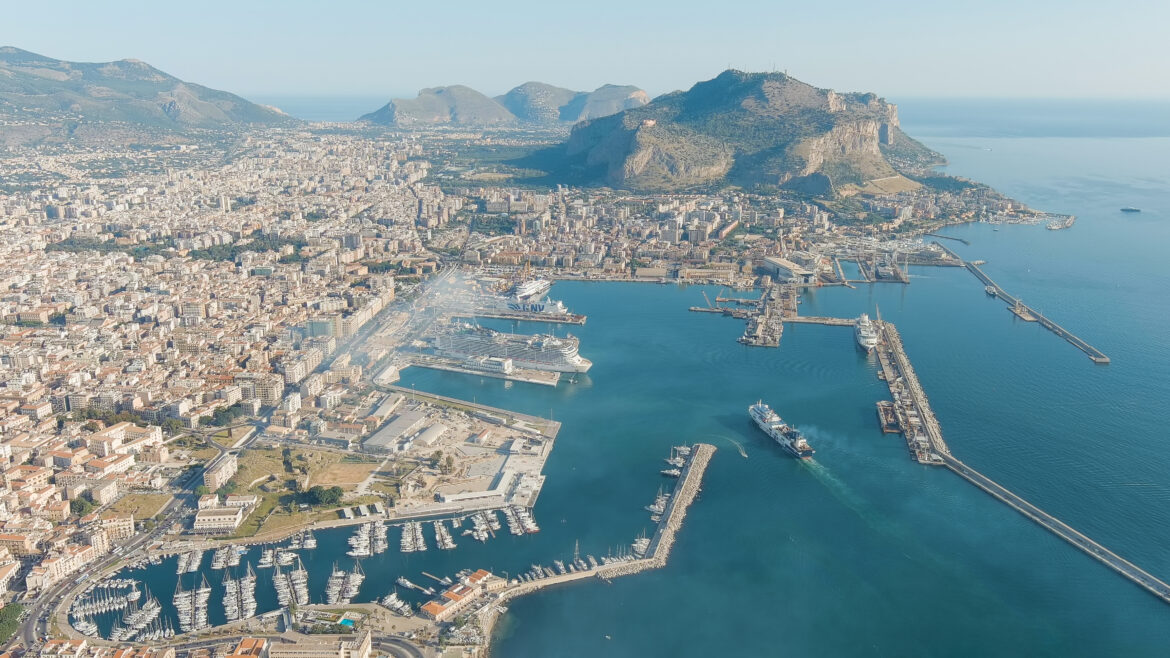 Palermo, Sicily, Italy – July 07, 2023: MSC Grandiosa cruise ship moored in the port of Palermo. Lots of smoke from the chimney. Palermo is the capital of Sicily, Aerial View